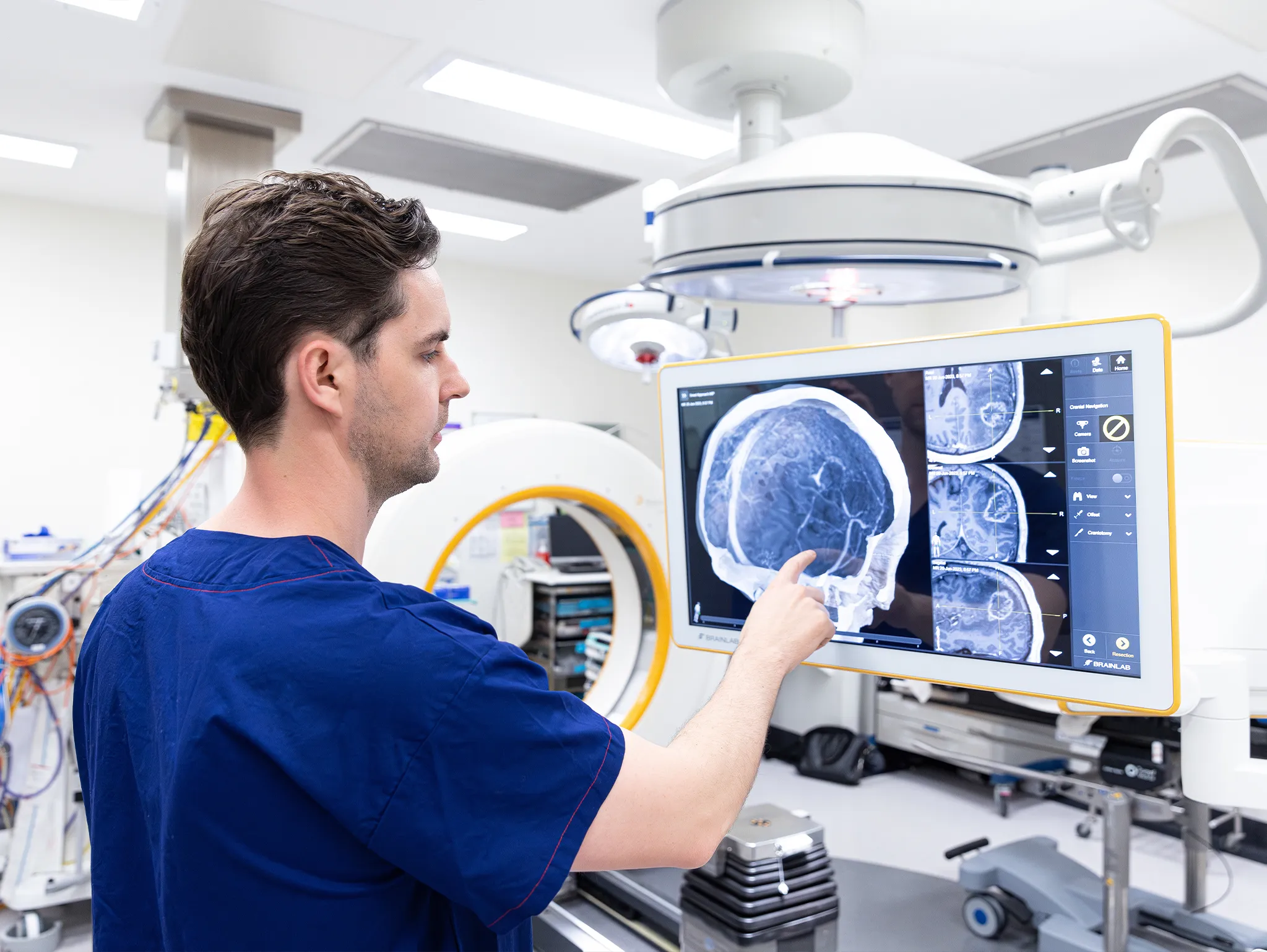 Doctor looking at scan on screen in operating theatre for corporate lifestyle image