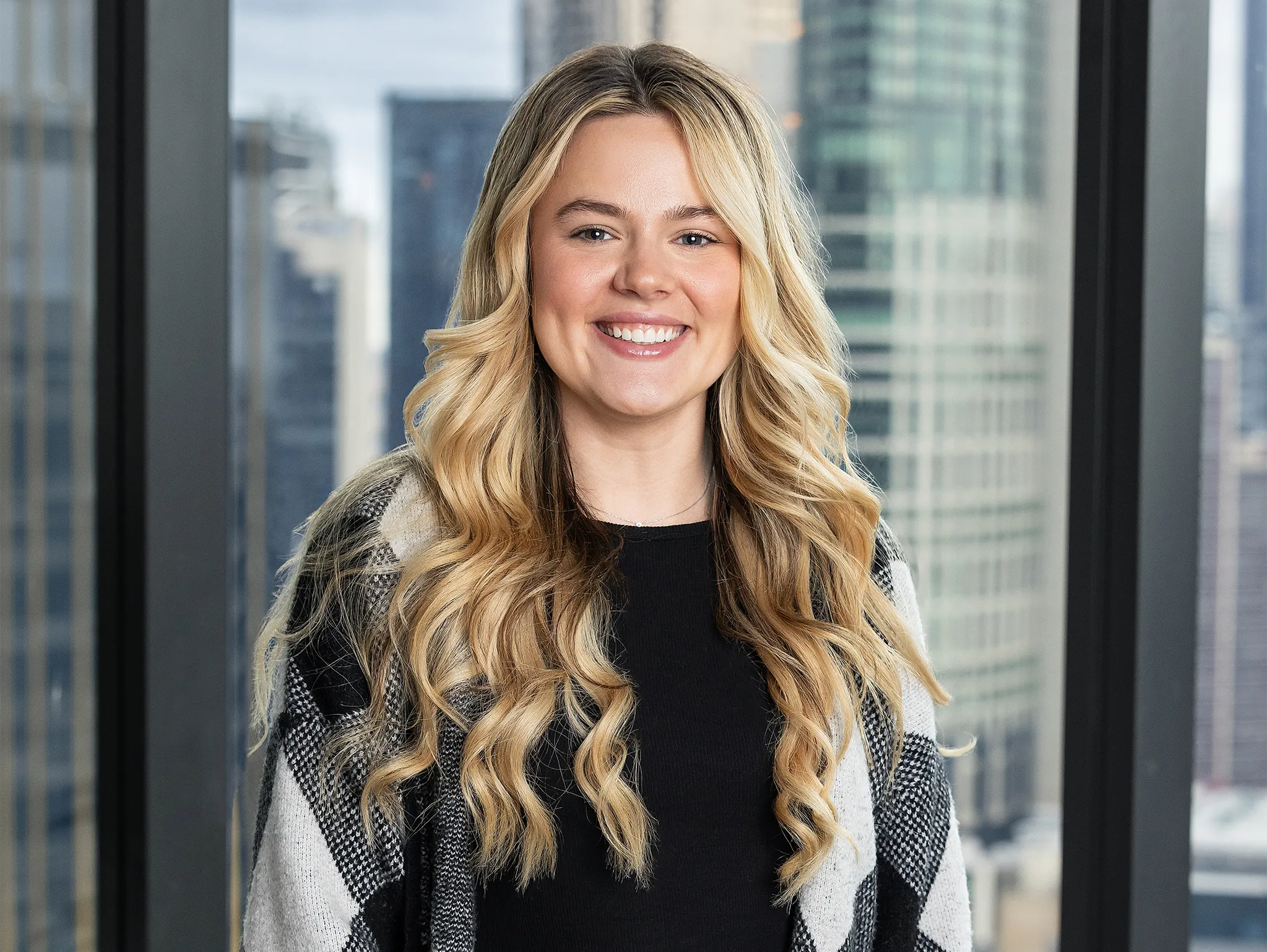 woman standing in office building posing for corporate headshots